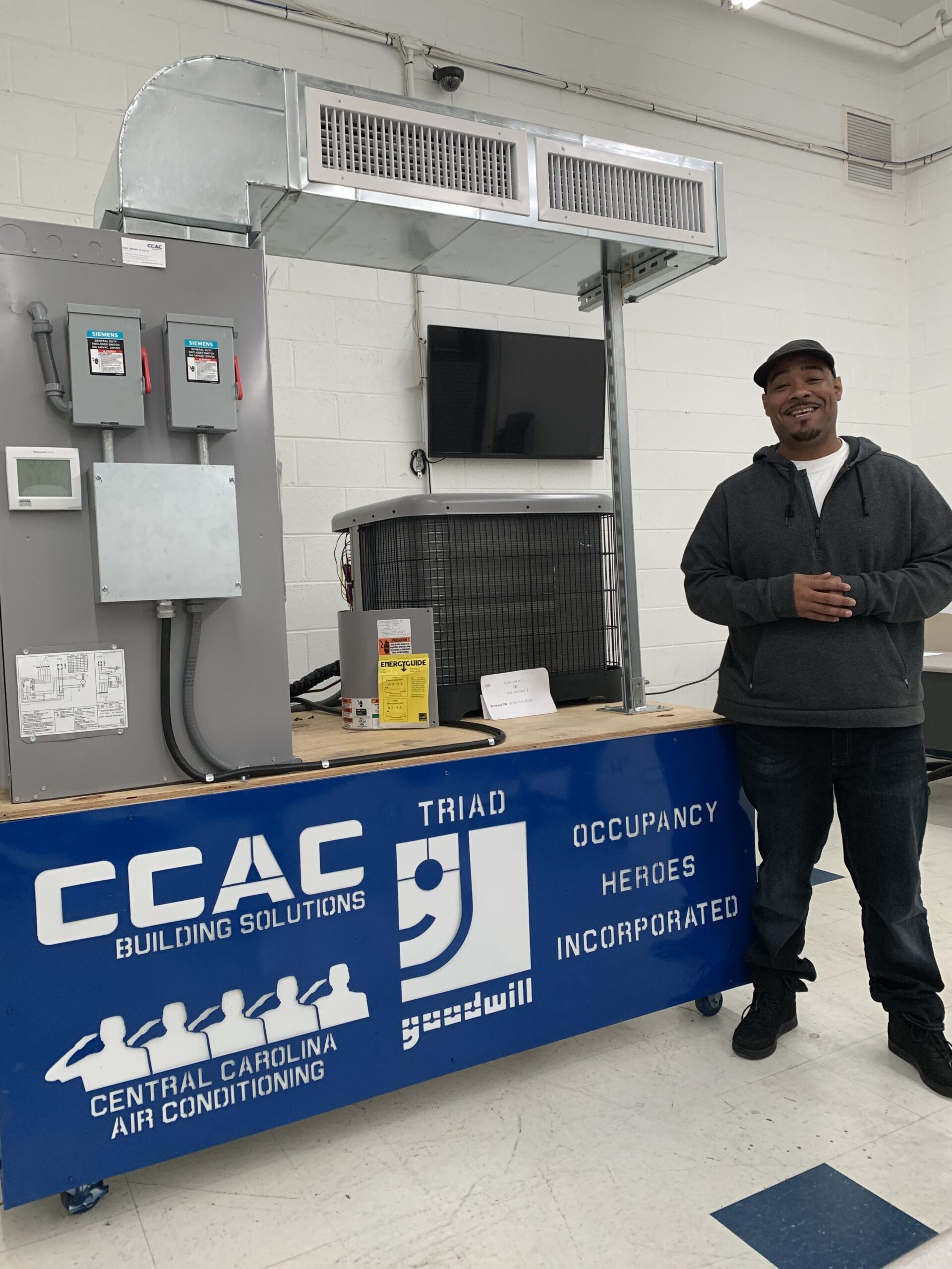 Russell Moore Smiling In Front of his HVAC Demonstration Unit 